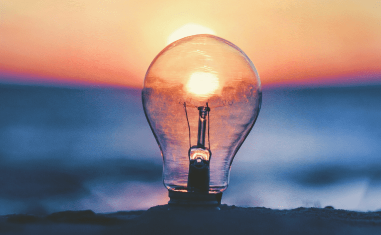 sun shining through lightbulb at the beach